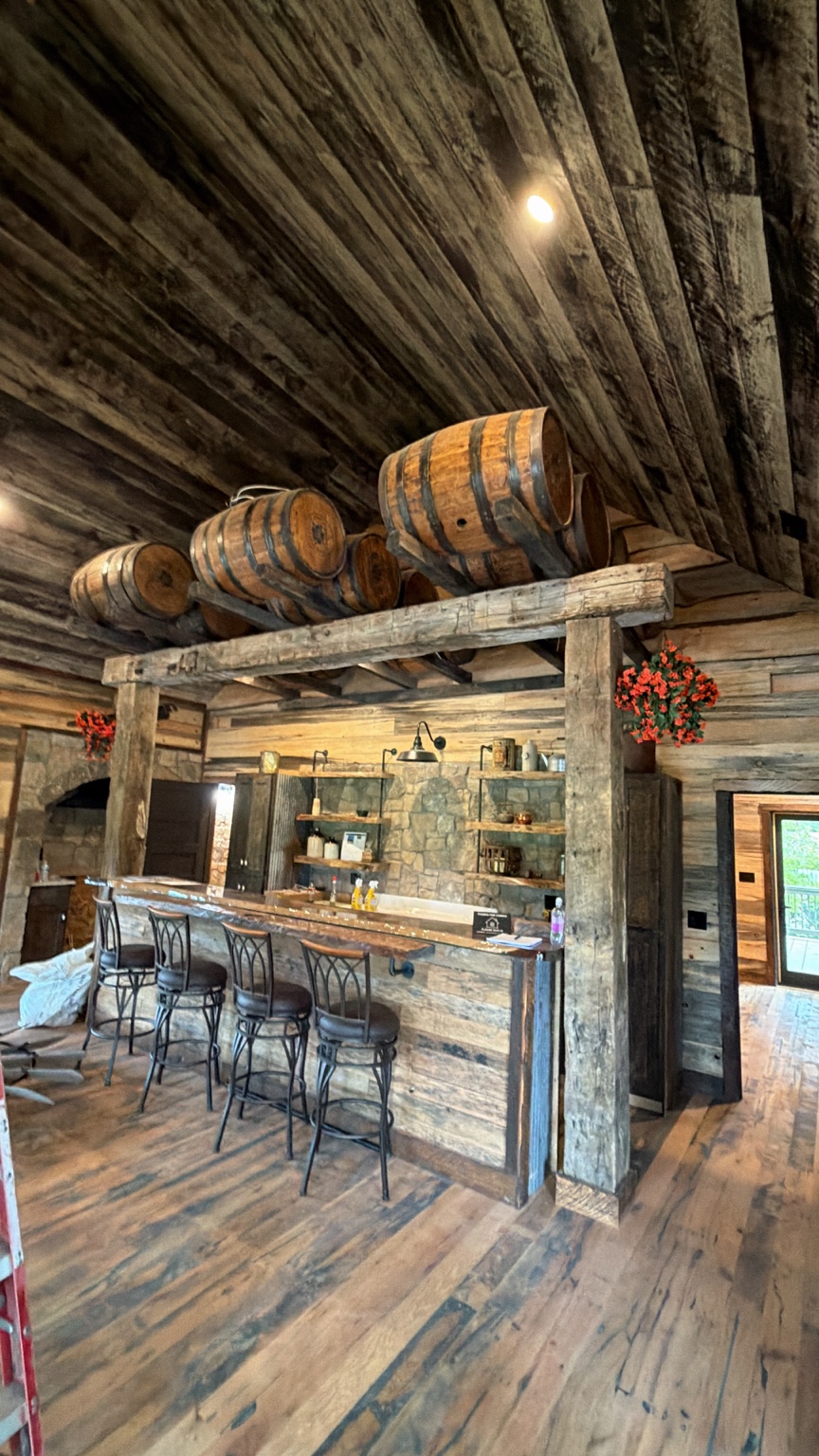 Bourbon barrels above a hand-hewn timber bar