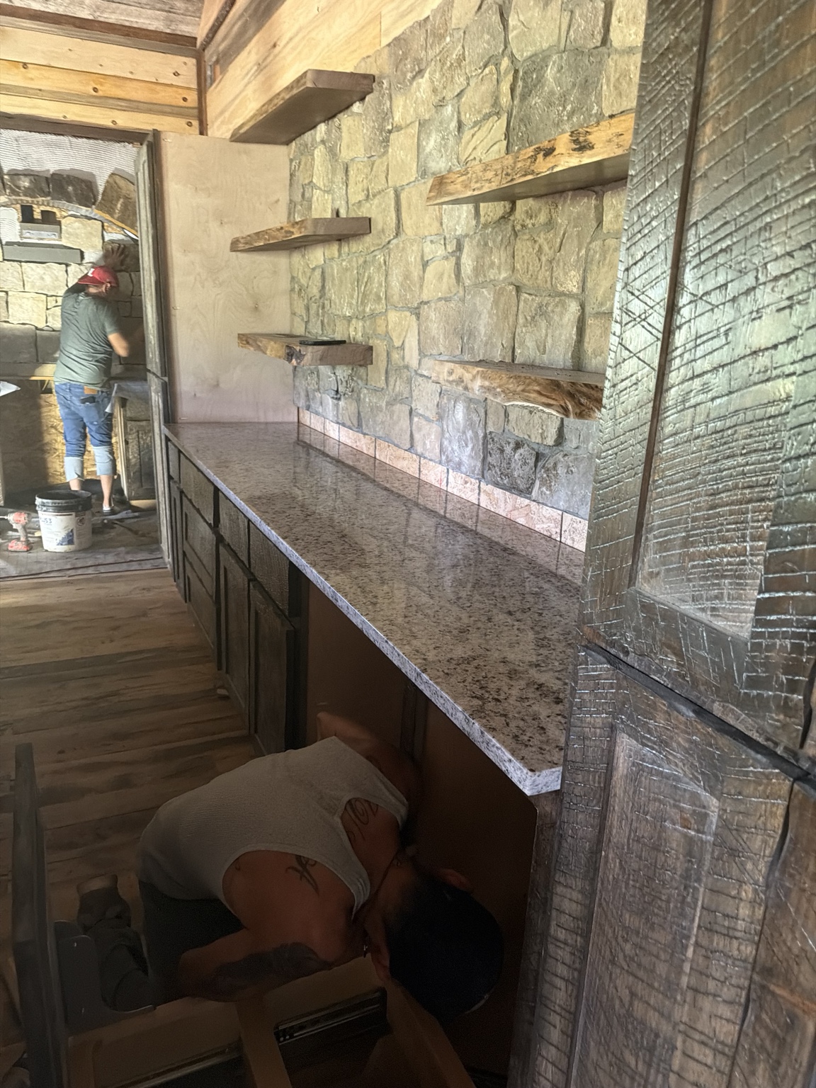 Craftsmen working on the rustic kitchen