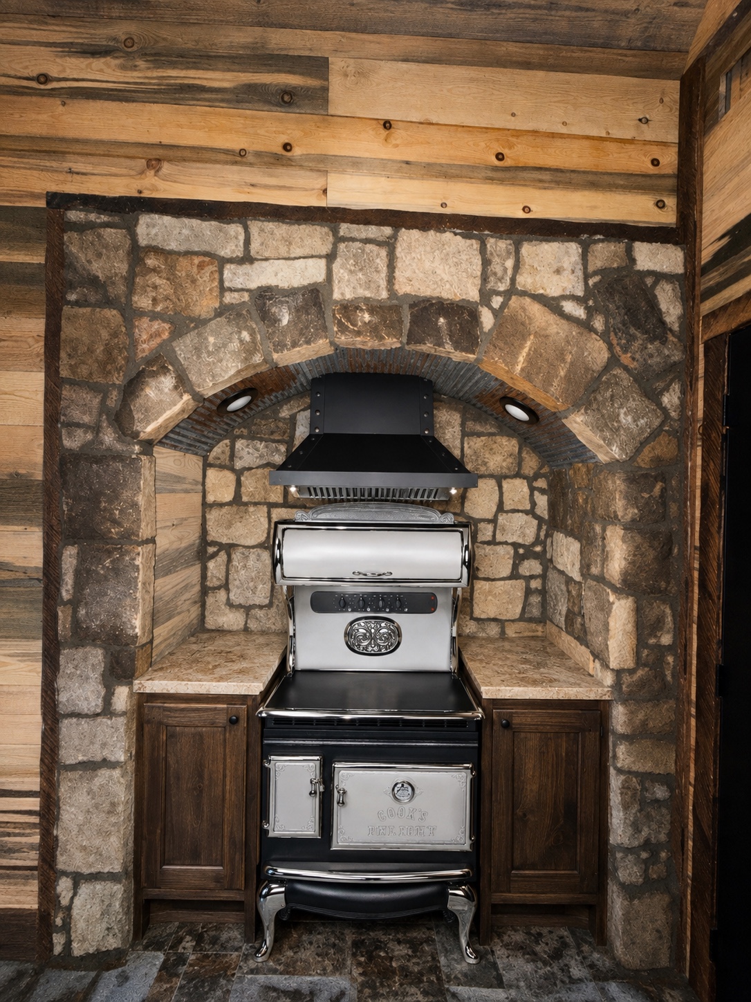 Vintage-style stove set inside a hand-laid stone arch
